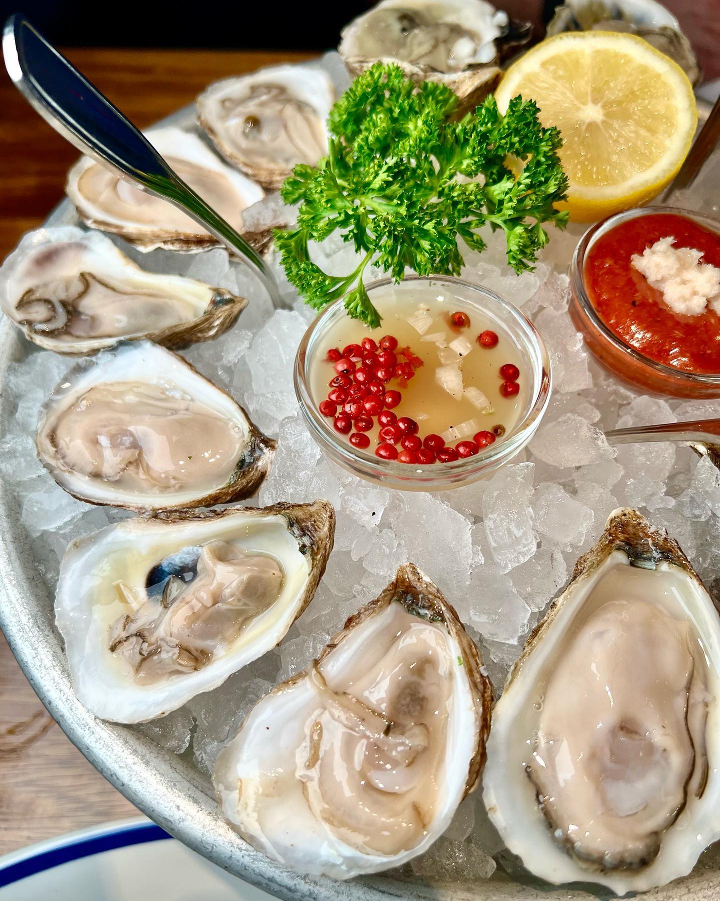 Hudson House signature dishes Oysters on the Half Shell, Lobster Roll, The Hudson Burger, various crudos and seafood towers.